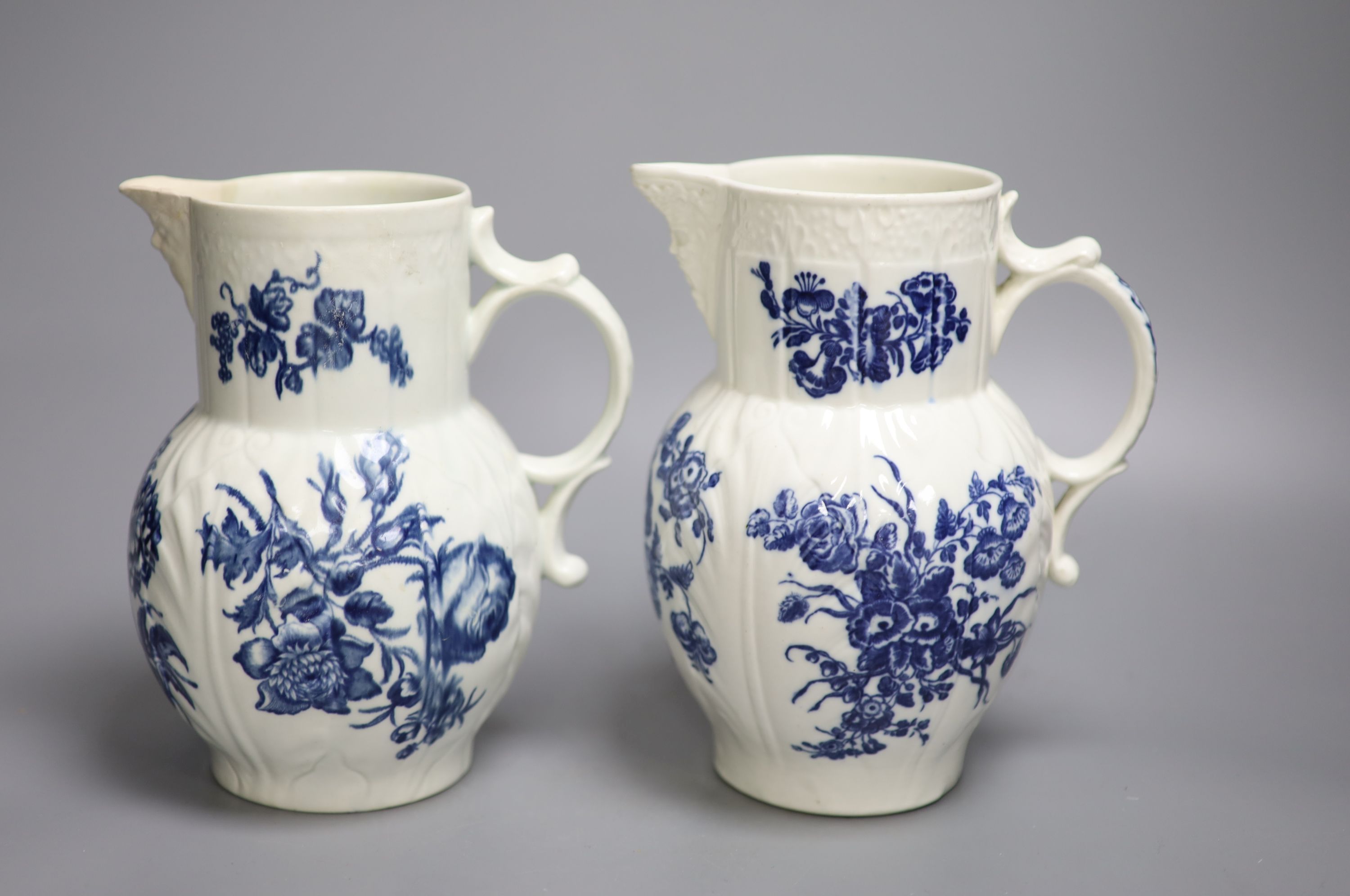 A Caughley mask jug printed with floral sprays and a Worcester mask jug, printed with Natural Sprays, the later with amateur repair to